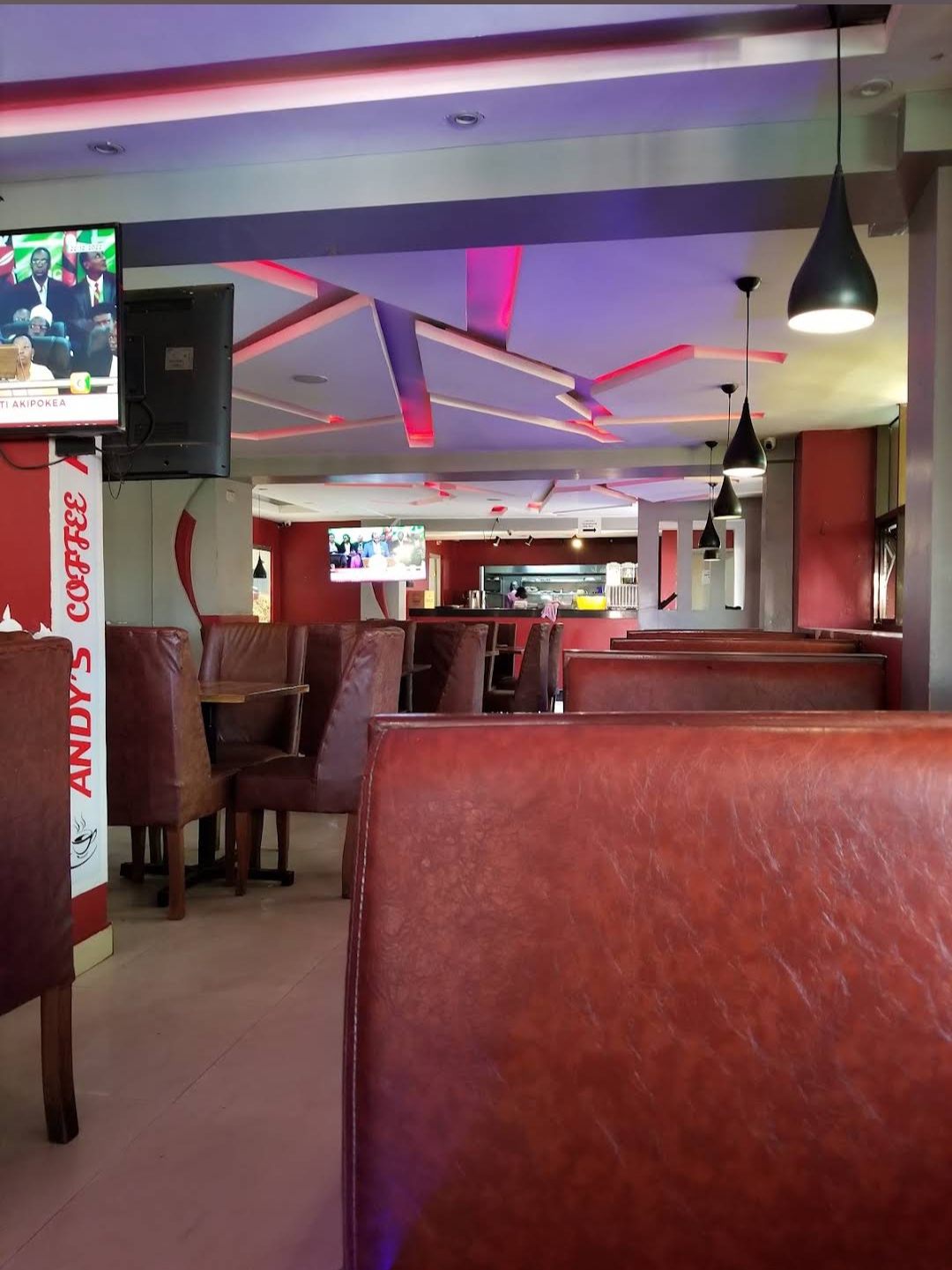 Warm leather booths and mood lighting inside Andy's Coffee House